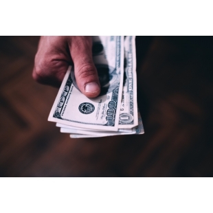 hand-holding-a-stack-of-paper-bills.jpg